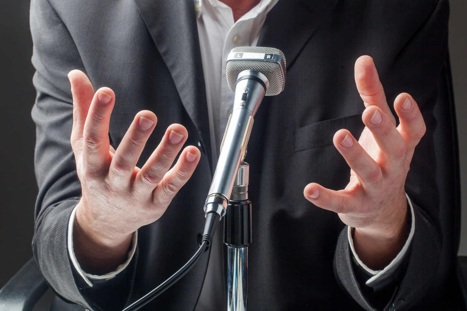 businessman speaking up in public on micro